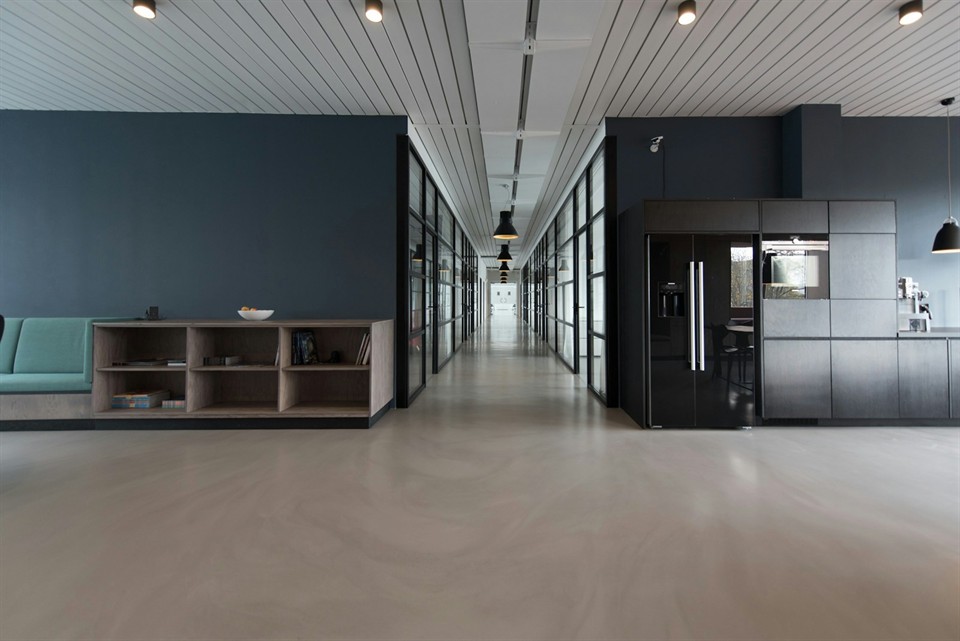Bright modern office workspace with desks and laptops